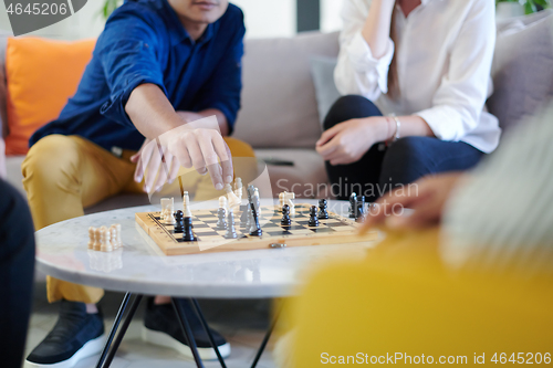 Image of multiethnic group of business people playing chess