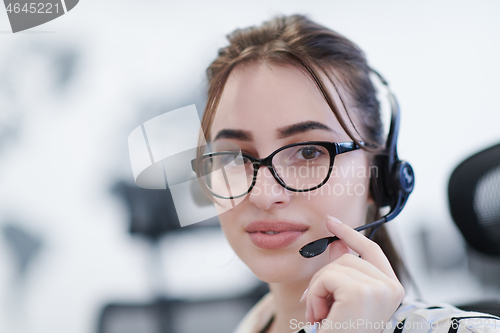 Image of Business woman with headsets at work