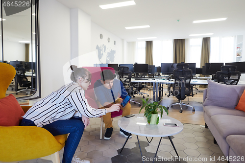 Image of Business people Working In Relaxation Area Of Modern Office