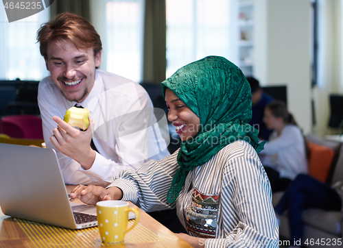 Image of international multicultural business team working together on la