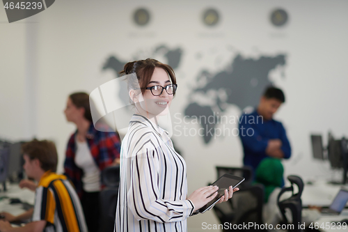 Image of portrait of businesswoman holding tablet computer