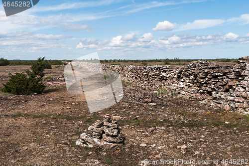 Image of Stone cairn by a trail along a dry stone wall