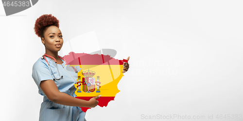 Image of Beautiful african-american doctor cares about Spain isolated over white studio background