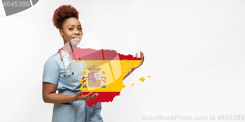 Image of Beautiful african-american doctor cares about Spain isolated over white studio background