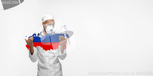 Image of Beautiful african-american doctor cares about Russia isolated over white studio background