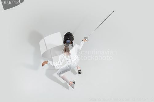 Image of Teen girl in fencing costume with sword in hand isolated on white background, top view