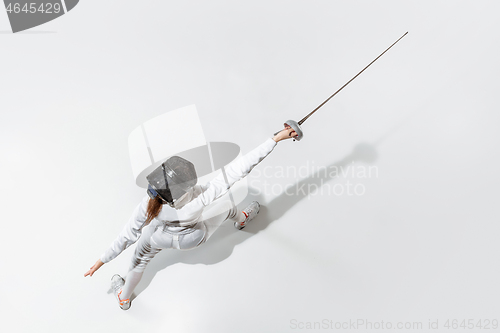 Image of Teen girl in fencing costume with sword in hand isolated on white background, top view