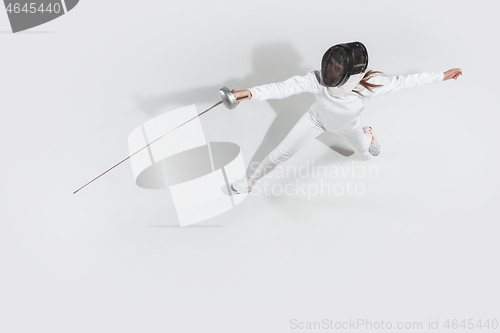 Image of Teen girl in fencing costume with sword in hand isolated on white background, top view