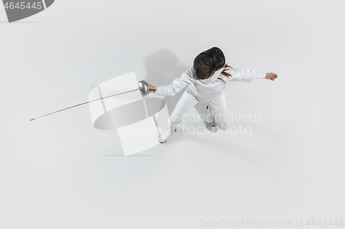 Image of Teen girl in fencing costume with sword in hand isolated on white background, top view