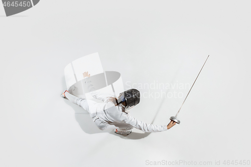 Image of Teen girl in fencing costume with sword in hand isolated on white background, top view