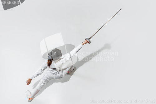 Image of Teen girl in fencing costume with sword in hand isolated on white background, top view