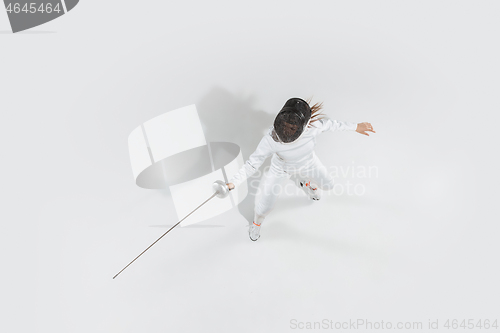 Image of Teen girl in fencing costume with sword in hand isolated on white background, top view