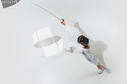 Image of Teen girl in fencing costume with sword in hand isolated on white background, top view