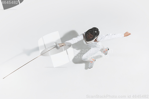 Image of Teen girl in fencing costume with sword in hand isolated on white background, top view