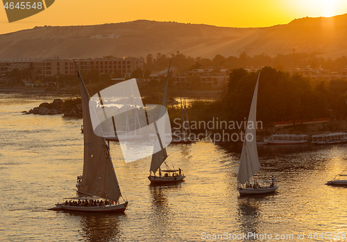 Image of felucca boats on Nile river  at sunset