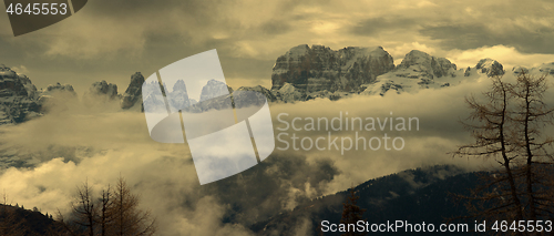 Image of Snow-capped alps mountains in clouds