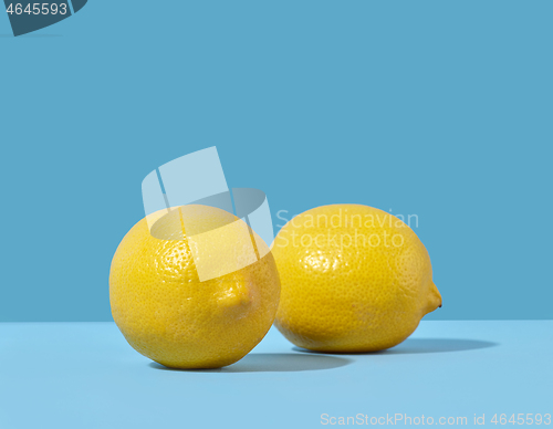 Image of fresh lemons on blue background