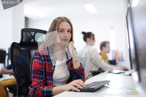 Image of casual business woman working on desktop computer