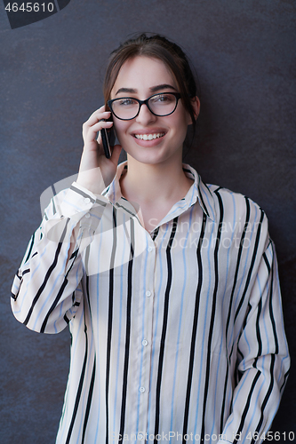 Image of startup businesswoman in shirt with a glasses using mobile phone