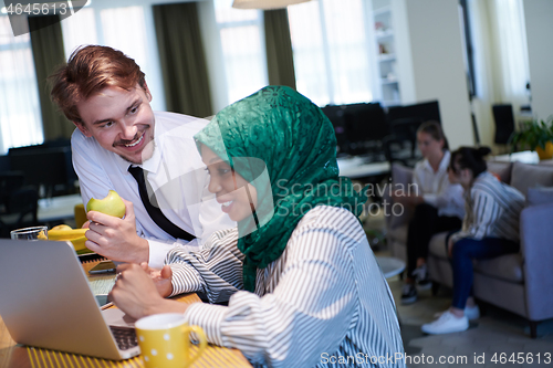 Image of international multicultural business team working together on la