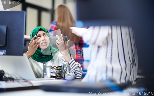Image of Multiethnic startup business team with Arabian woman