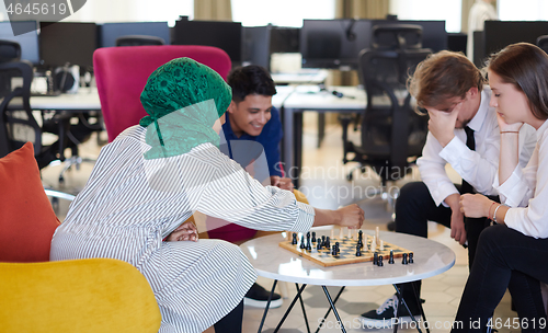 Image of multiethnic group of business people playing chess