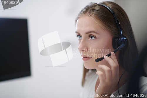 Image of Business woman with headsets at work