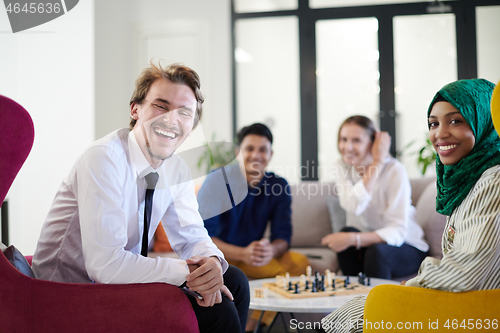 Image of multiethnic group of business people playing chess