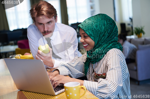 Image of international multicultural business team working together on la