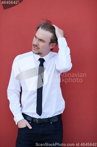 Image of portrait of startup businessman in front of pink wall