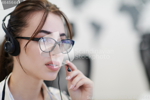 Image of Business woman with headsets at work