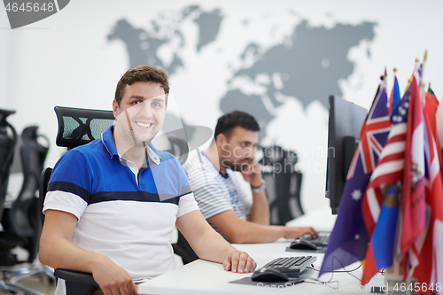 Image of two male software developers working on computer