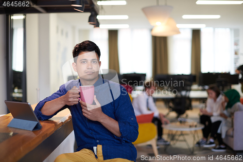 Image of casual indian business man taking break from the work