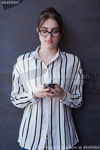 Image of startup businesswoman in shirt with a glasses using mobile phone