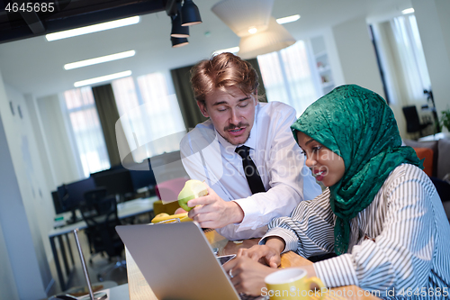 Image of international multicultural business team working together on la