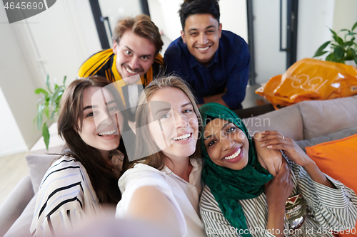 Image of group of casual multiethnic business people taking selfie