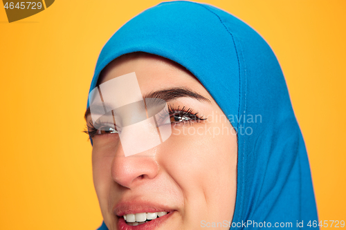 Image of Portrait of young muslim woman isolated on yellow studio background