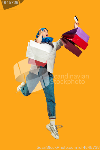 Image of Portrait of young muslim woman isolated on yellow studio background