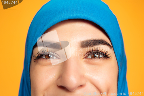 Image of Portrait of young muslim woman isolated on yellow studio background