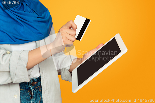 Image of Close up portrait of young muslim woman isolated on yellow studio background