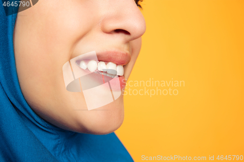 Image of Portrait of young muslim woman isolated on yellow studio background