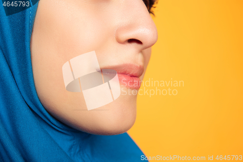 Image of Portrait of young muslim woman isolated on yellow studio background