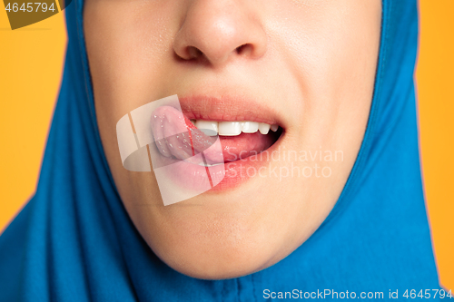 Image of Portrait of young muslim woman isolated on yellow studio background