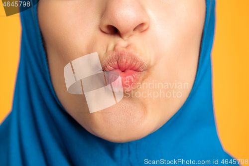 Image of Portrait of young muslim woman isolated on yellow studio background