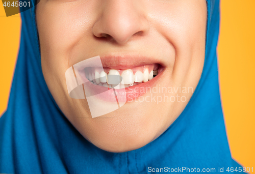 Image of Portrait of young muslim woman isolated on yellow studio background