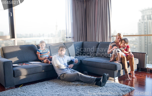 Image of Happy Young Family Playing Together on sofa