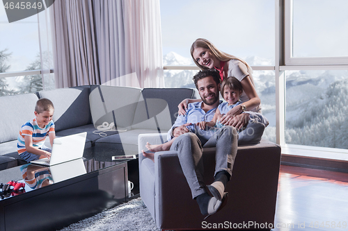 Image of happy young couple spending time with kids