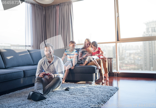 Image of Happy family playing a video game