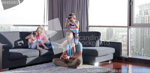 Image of Happy family playing a video game