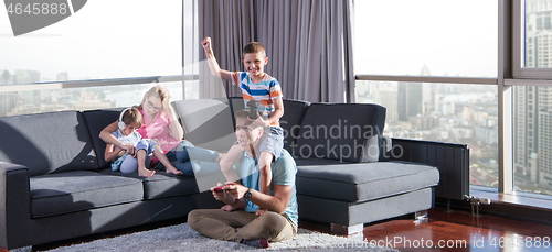 Image of Happy family playing a video game